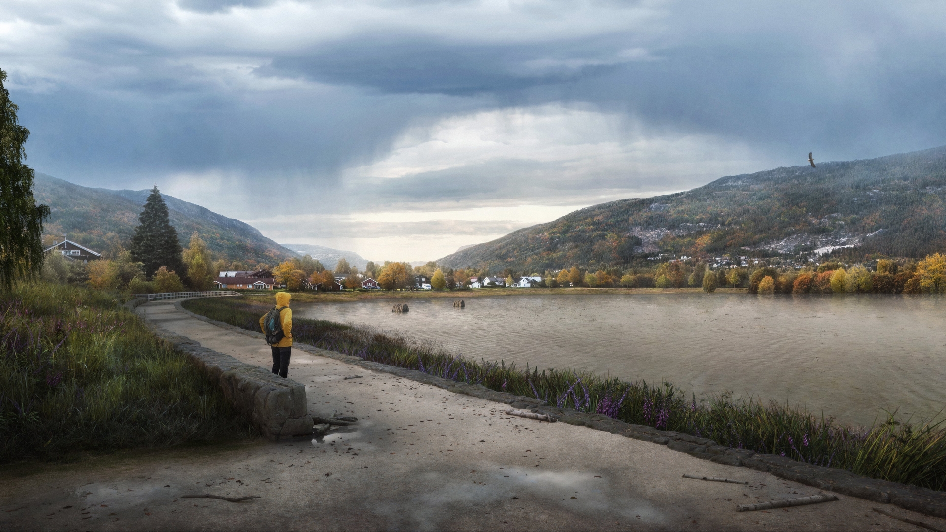A person wearing a yellow raincoat stands on a paved path beside a lake, surrounded by a scenic landscape. The path is lined with grass and purple flowers, leading towards distant houses nestled among trees with autumn foliage. Majestic mountains rise in the background under a cloudy sky, with a bird soaring above.